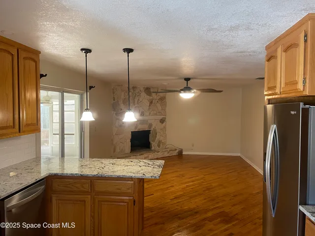 a kitchen with kitchen island a counter top space appliances and cabinets
