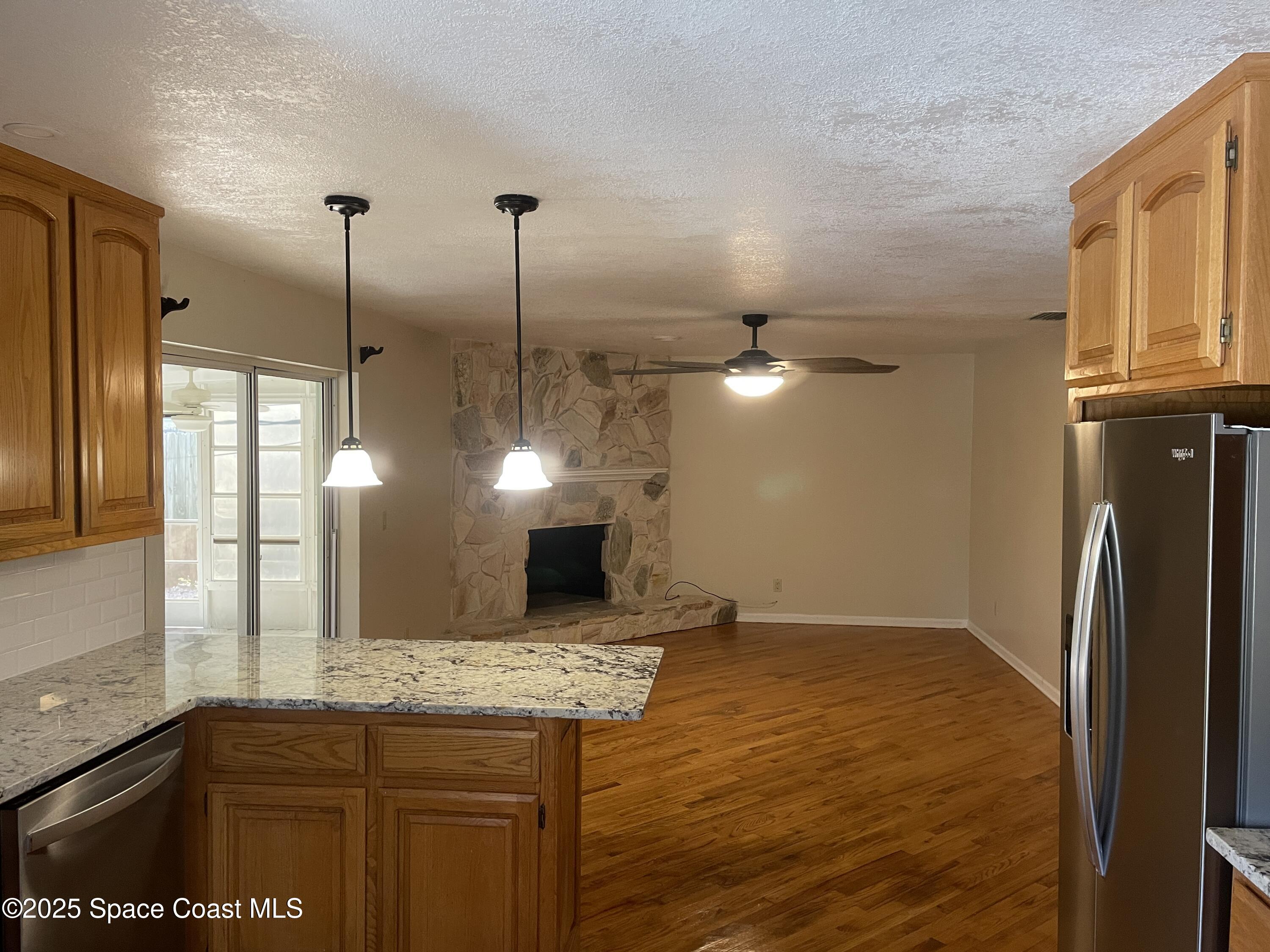 104 Jupiter Court Indialantic, FL 32903 - Photo 6 of 28 a kitchen with kitchen island a counter top space appliances and cabinets