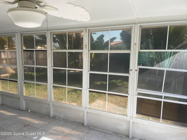 a view of a house with a large window and wooden floor