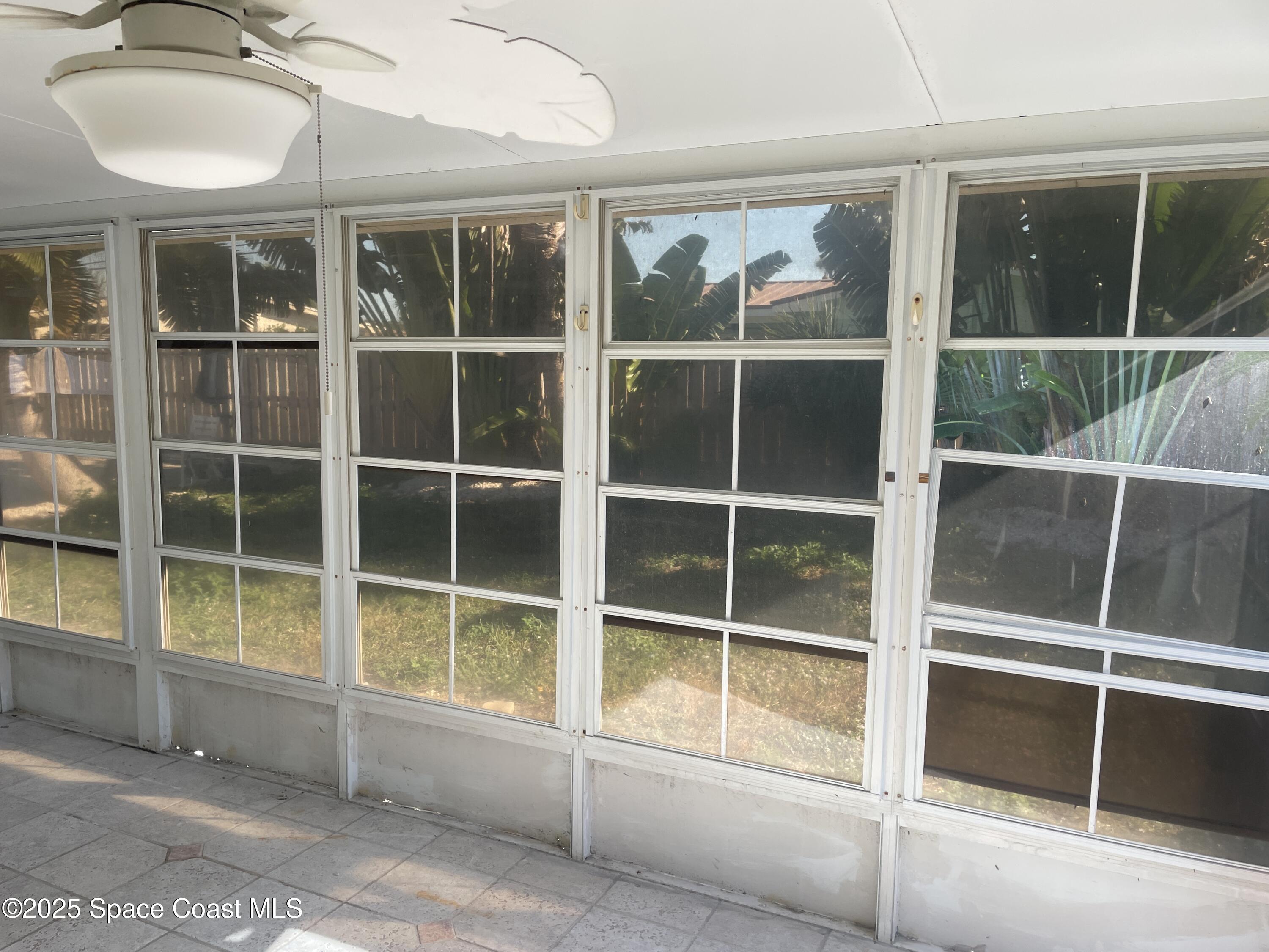 104 Jupiter Court Indialantic, FL 32903 - Photo 8 of 28 a view of a house with a large window and wooden floor