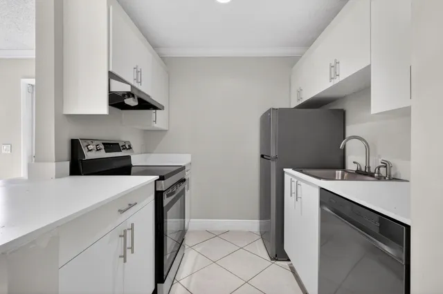 a kitchen with stainless steel appliances a sink stove and refrigerator