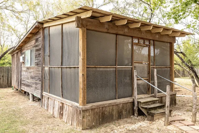 a view of a house with a wooden fence and floor
