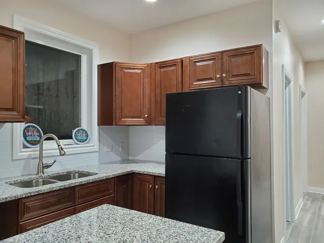 a kitchen with a refrigerator and a sink