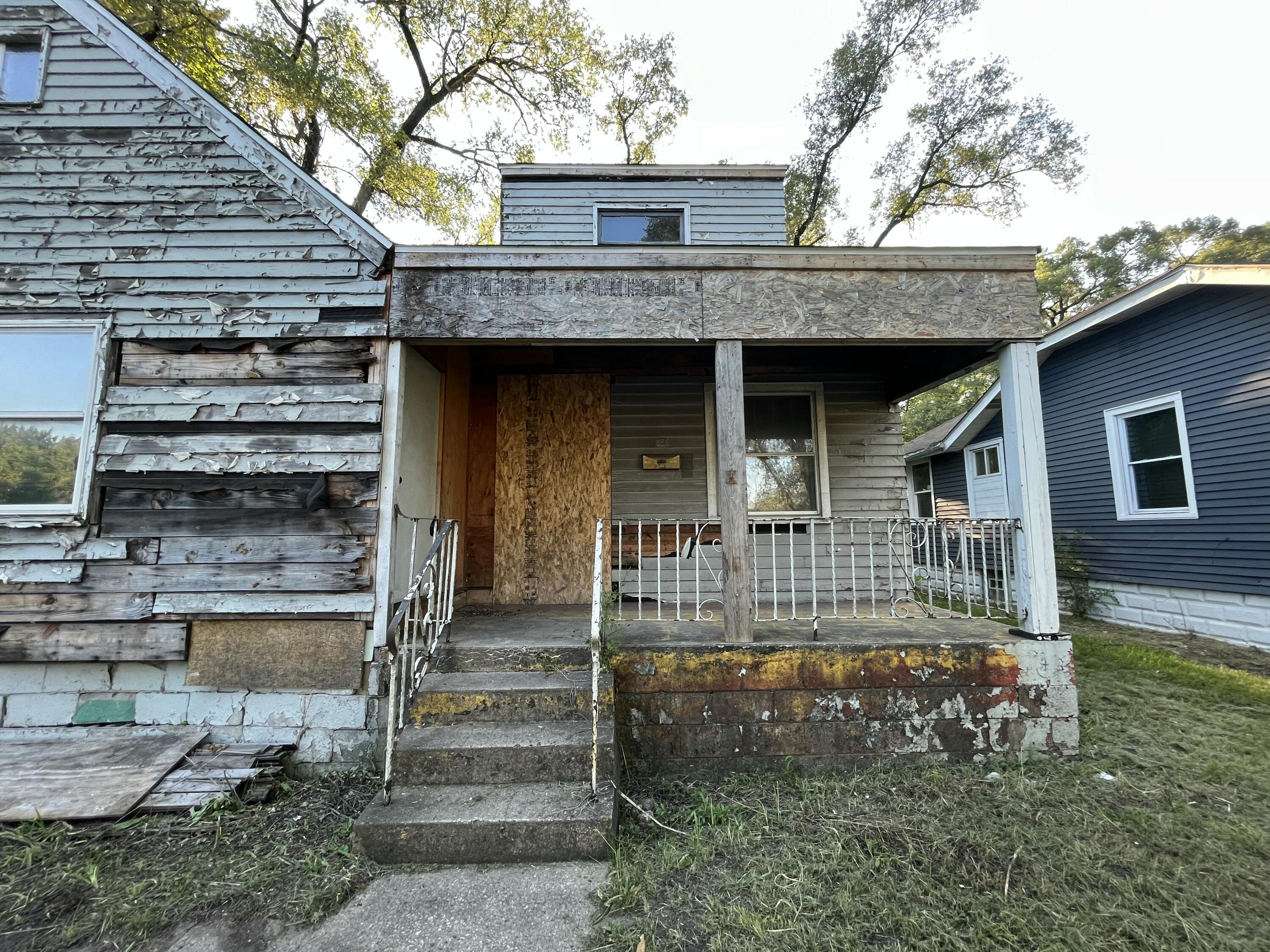 856 Kentucky Street Gary, IN 46402 - Photo 14 of 16 a front view of a house with a yard