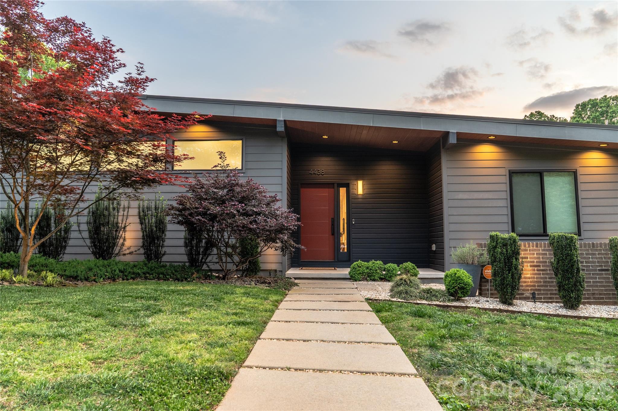 4438 Raney Way Charlotte, NC 28205 - Photo 1 of 34 a front view of a house with a yard and potted plants