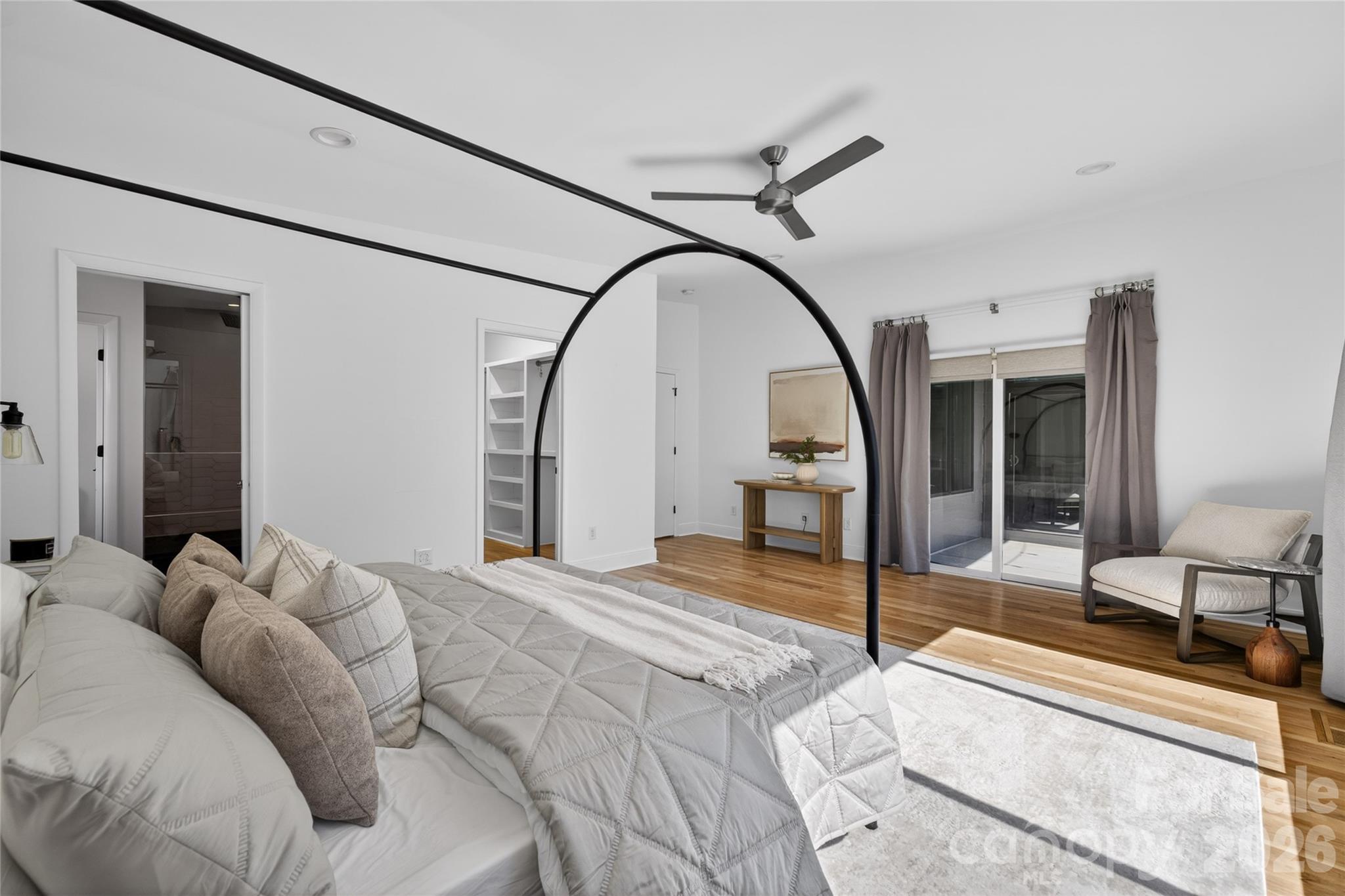 4438 Raney Way Charlotte, NC 28205 - Photo 20 of 34 a spacious bedroom with a large bed and a chandelier