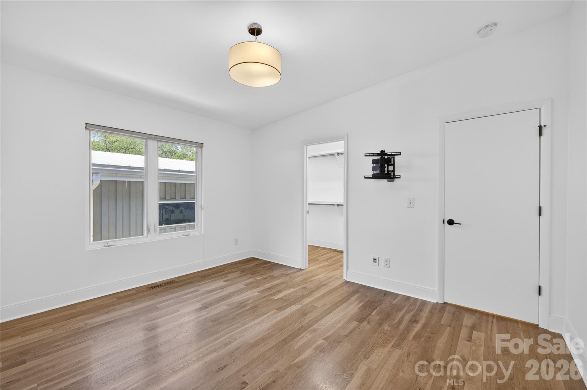 4438 Raney Way Charlotte, NC 28205 - Photo 26 of 34 a view of empty room with wooden floor and fan