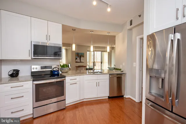 a kitchen with stainless steel appliances a stove sink and refrigerator