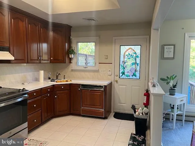a kitchen with a sink cabinets and wooden floor