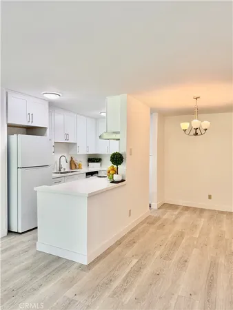 a kitchen with cabinets and a stainless steel appliances