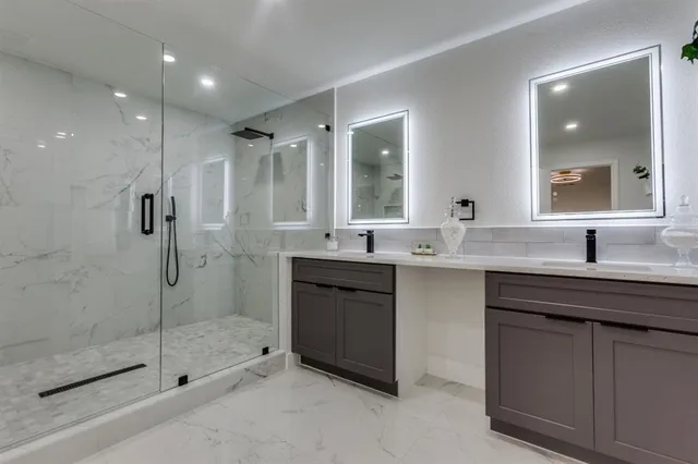a bathroom with a shower sink and mirror