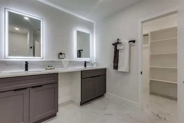 a bathroom with a double vanity sink a and a mirror