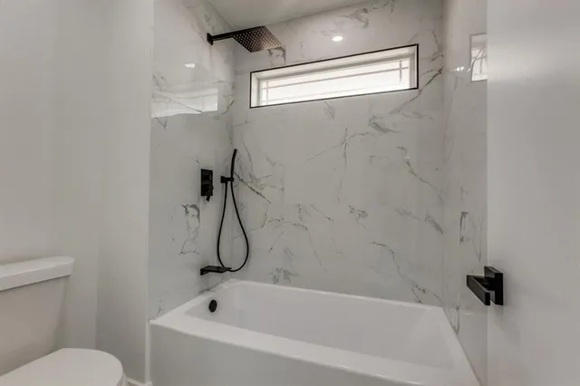 a bathroom with a bath tub and a shower