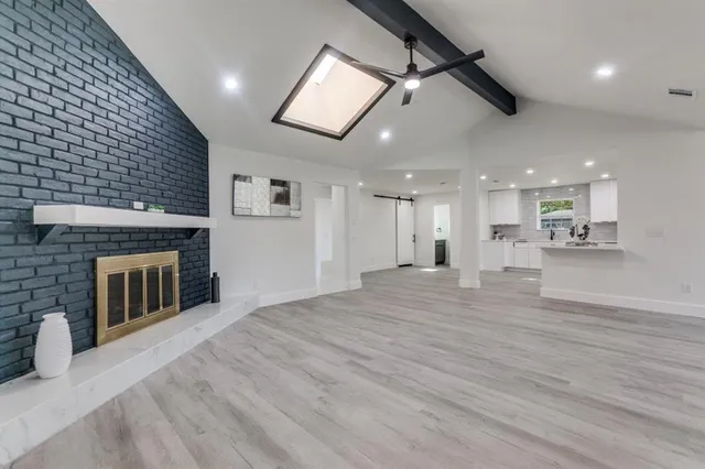 a view of an empty room with a fireplace