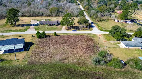 an aerial view of a houses with yard