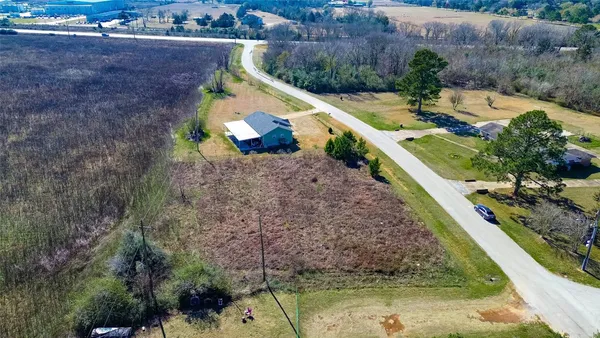 a view of a backyard with plants and a lake view