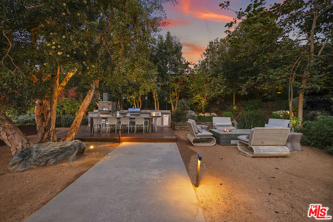 612 East Channel Road Santa Monica, CA 90402 - Photo 32 of 72 a view of a patio with couches and a table and chairs with wooden fence
