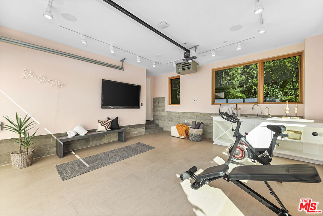 612 East Channel Road Santa Monica, CA 90402 - Photo 50 of 72 a room with gym equipment and a large window