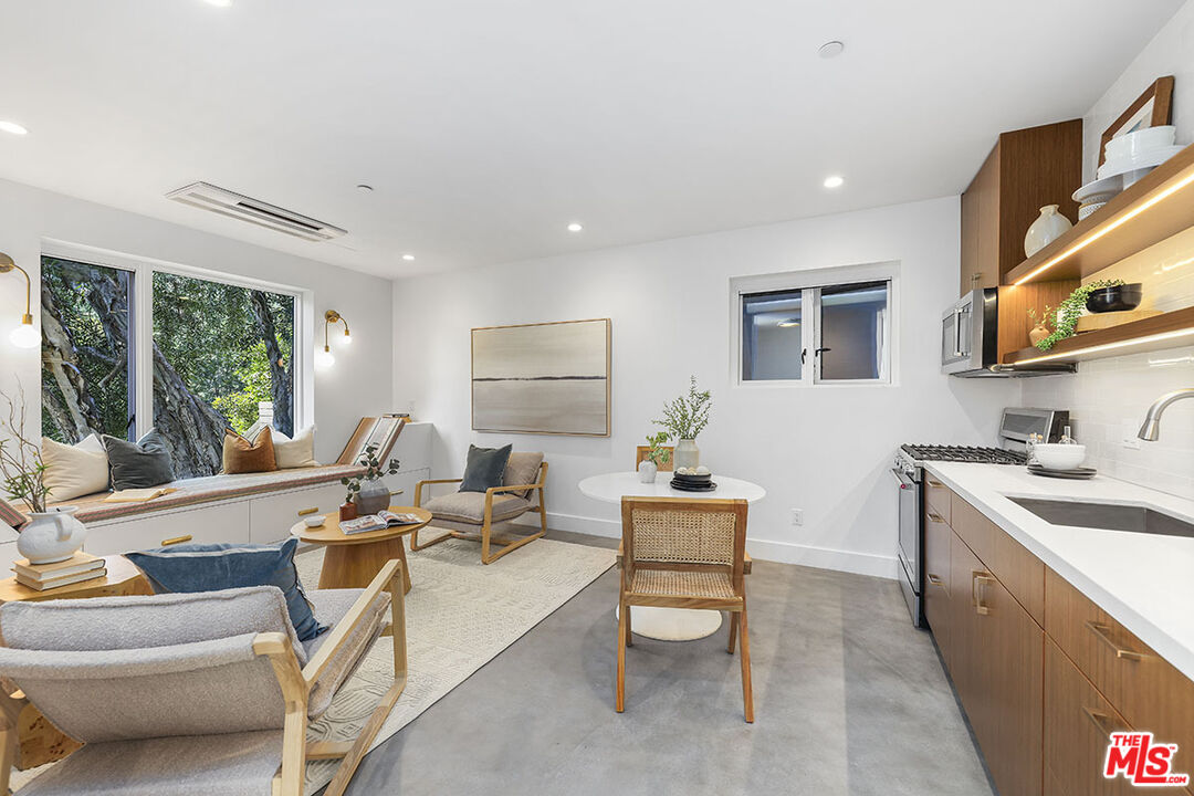 612 East Channel Road Santa Monica, CA 90402 - Photo 52 of 72 a living room with furniture a large window and a table