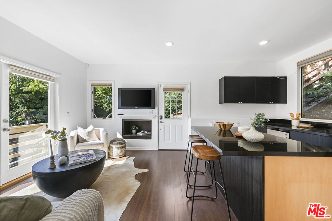612 East Channel Road Santa Monica, CA 90402 - Photo 65 of 72 a living room with furniture a fireplace and a flat screen tv