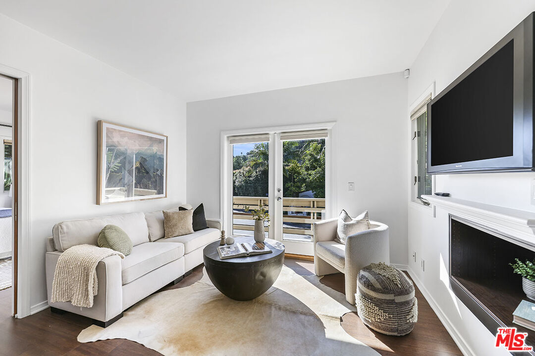 612 East Channel Road Santa Monica, CA 90402 - Photo 67 of 72 a living room with furniture a flat screen tv and a fireplace