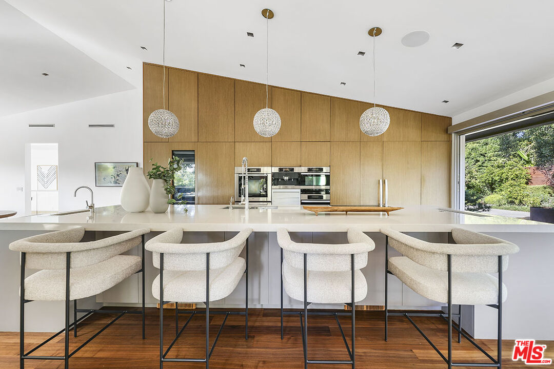 612 East Channel Road Santa Monica, CA 90402 - Photo 7 of 72 a kitchen with a sink and chairs