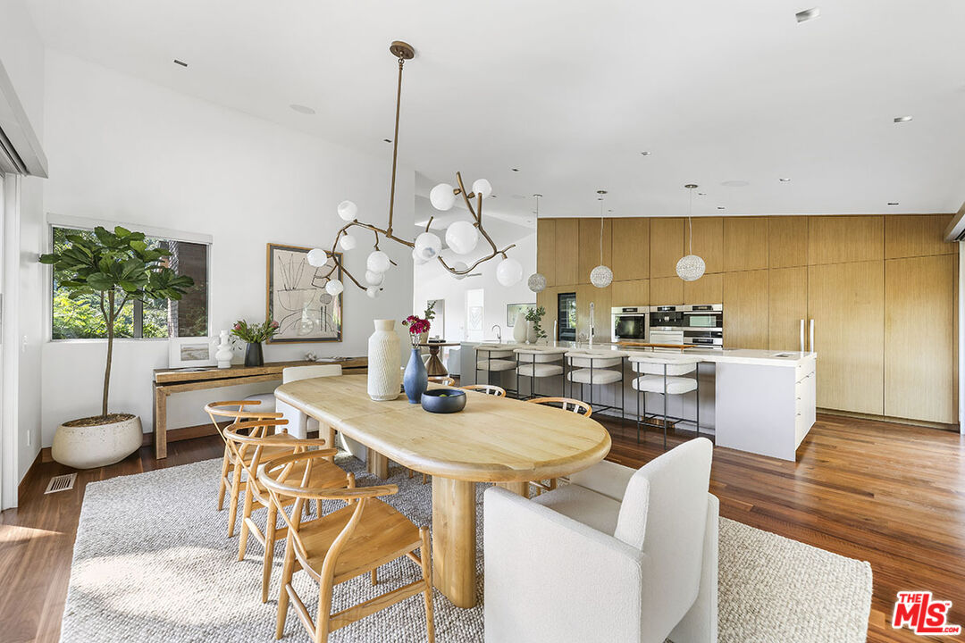 612 East Channel Road Santa Monica, CA 90402 - Photo 8 of 72 a view of a dining room with furniture a potted plant and wooden floor