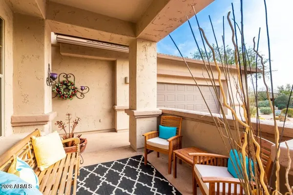 a view of a chair and table in the balcony