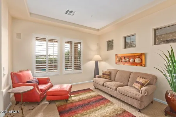 a living room with furniture a dining table and chairs with wooden floor