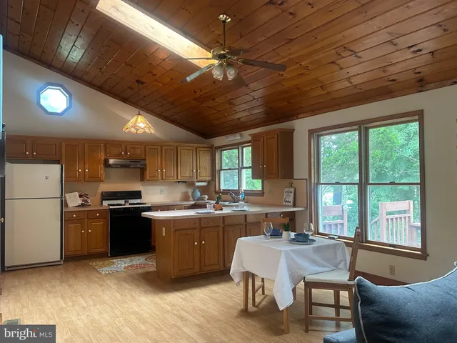 a kitchen with sink cabinets and wooden floor