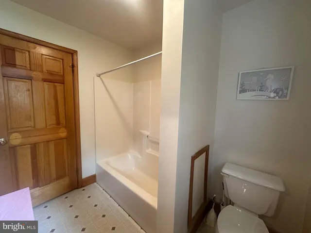 a bathroom with a toilet and shower