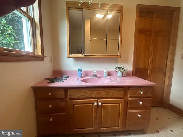a bathroom with a sink a vanity and mirror
