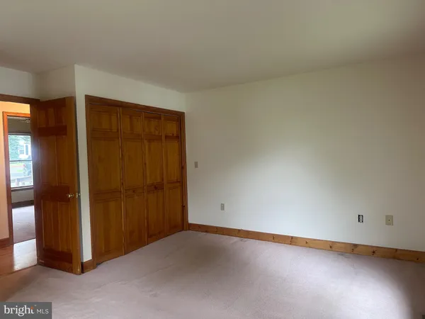 an empty room with closet area