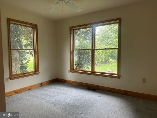 a view of an empty room with windows