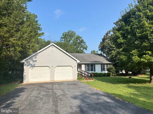 a view of house with yard and green space