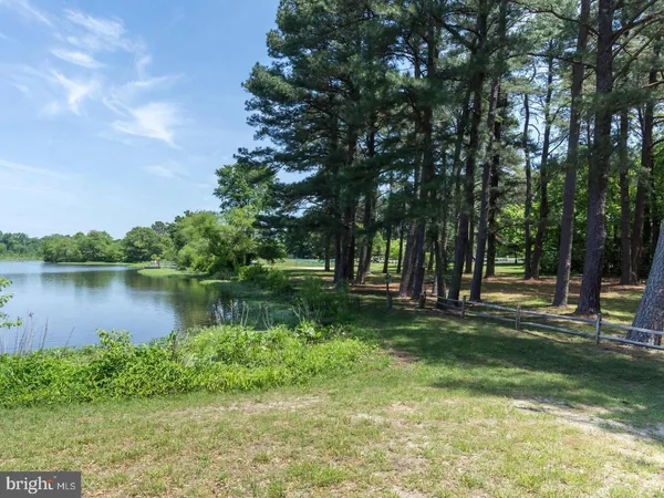 a view of a lake with a house in the background