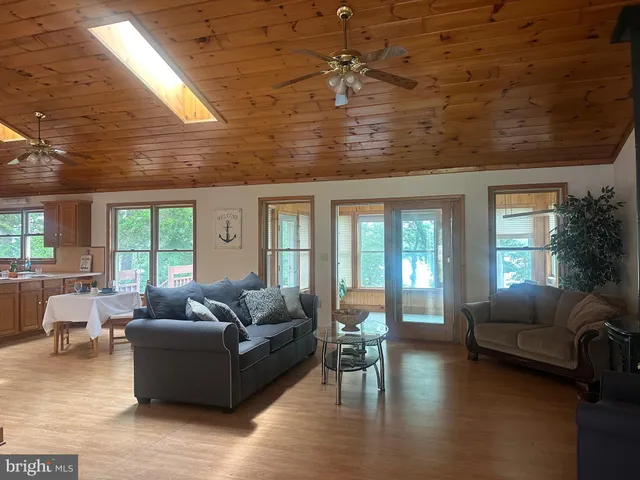 a living room with furniture wooden floor and a large window