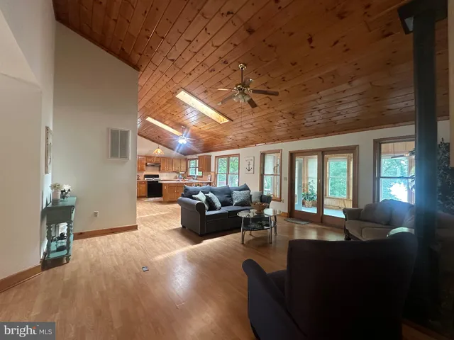 a living room with furniture window and wooden floor