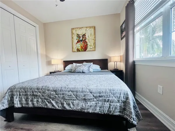 a bedroom with bed and window