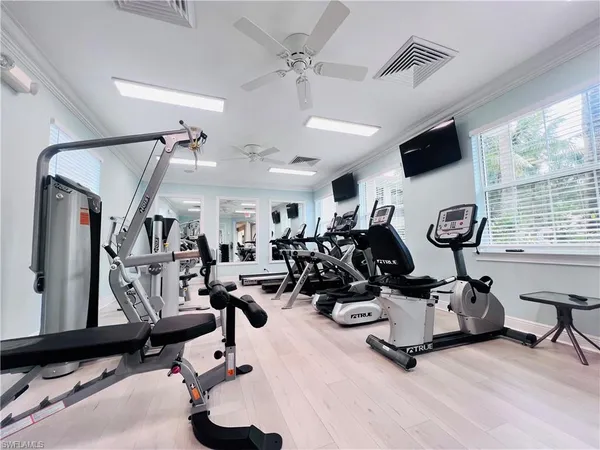 a living room with gym equipment and a large window