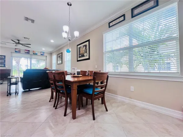 a view of a dining room with furniture and a window