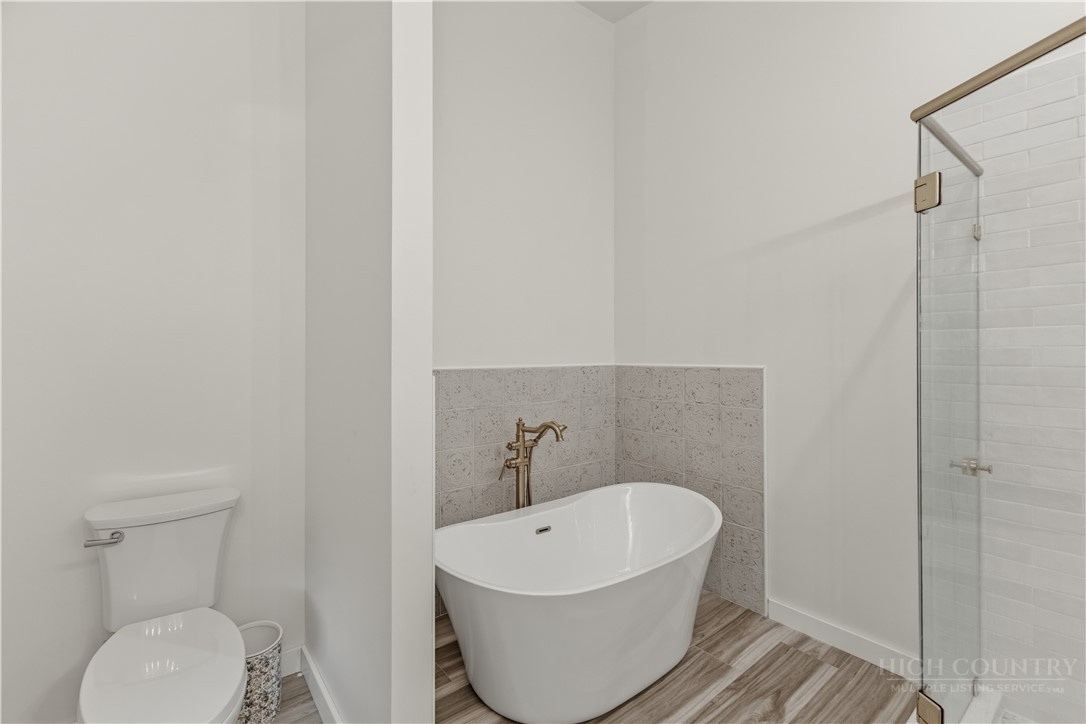 355 South River Hills Road Lansing, NC 28643 - Photo 30 of 45 a white bath tub sitting in a bathroom