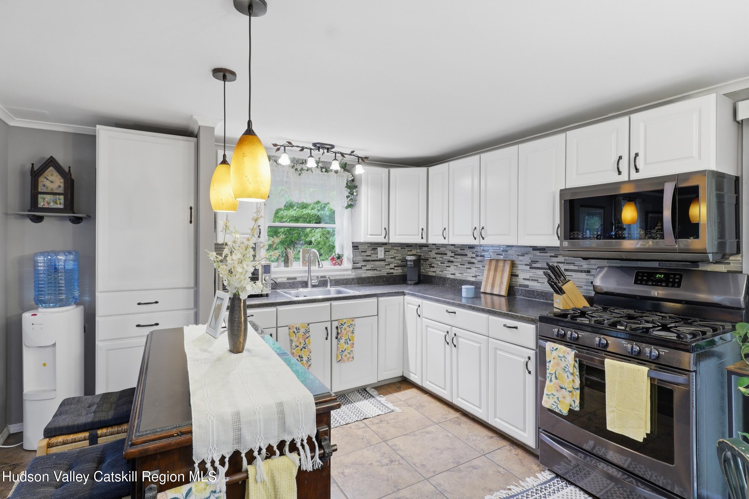 186 Cedar Hill Road High Falls, NY 12440 - Photo 10 of 33 a kitchen with stainless steel appliances granite countertop a stove a sink and a white cabinets