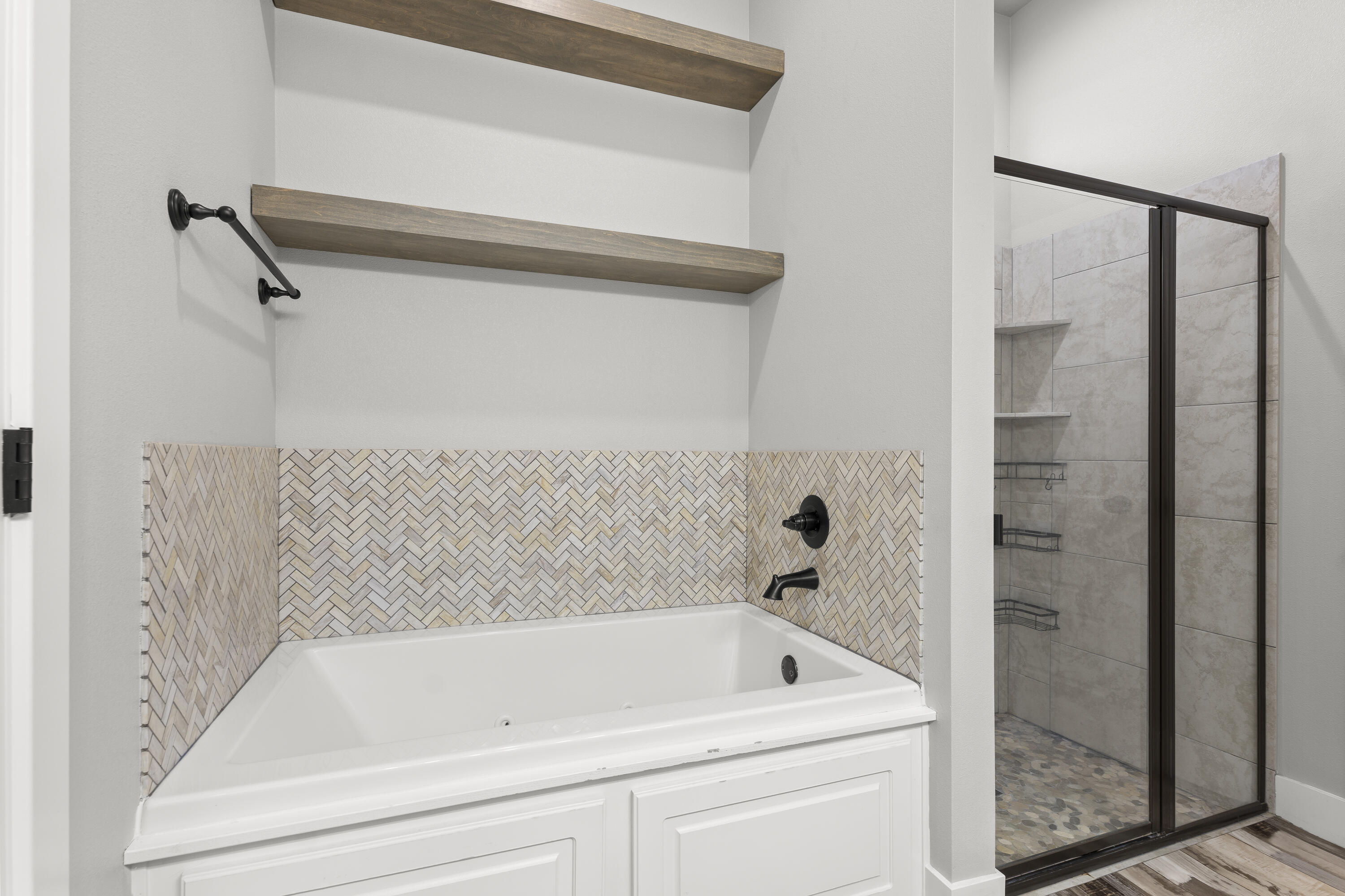 7605 58th Street Lubbock, TX 79407 - Photo 12 of 19 a bathroom with a tub and a shower