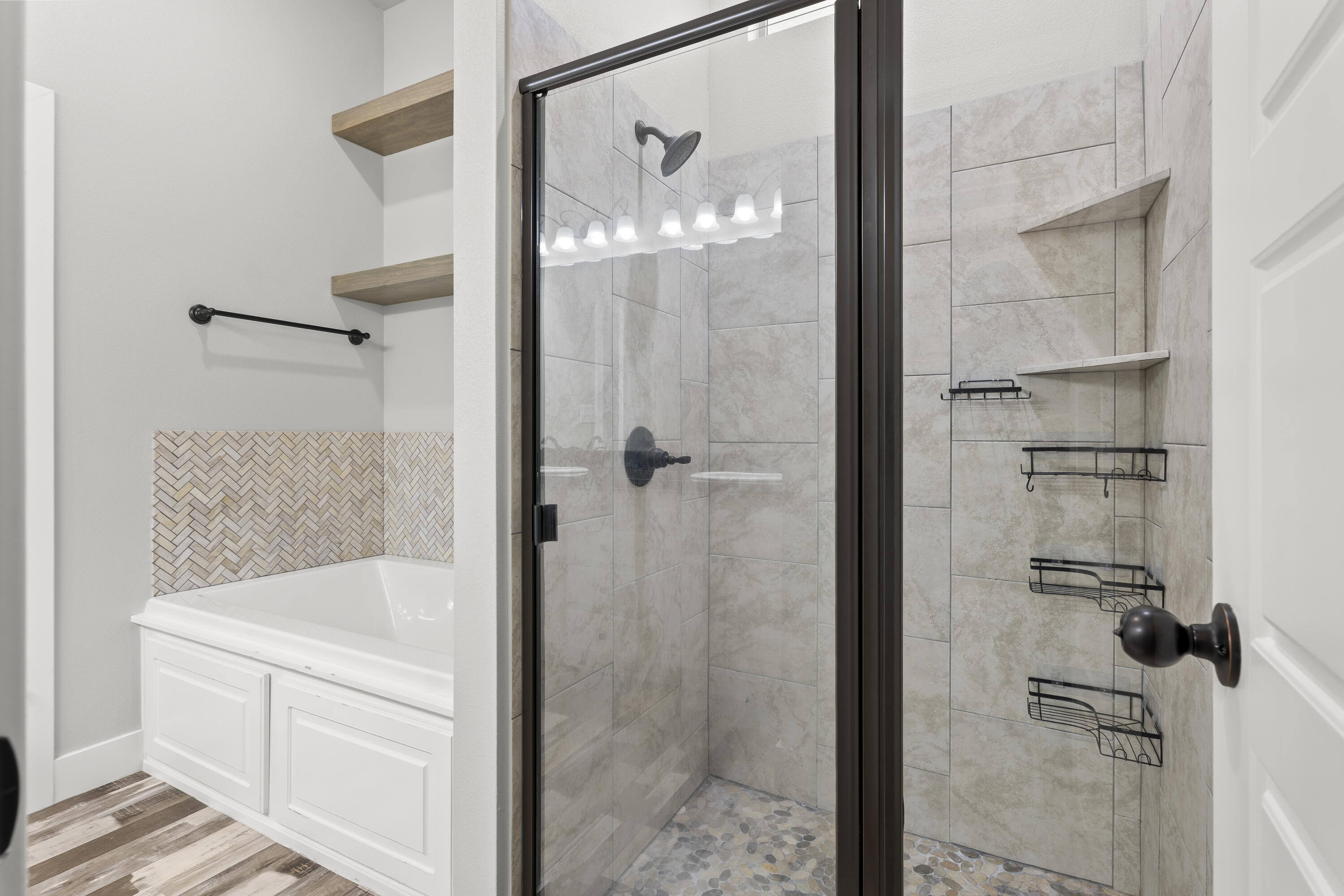 7605 58th Street Lubbock, TX 79407 - Photo 13 of 19 a bathroom with a glass shower door