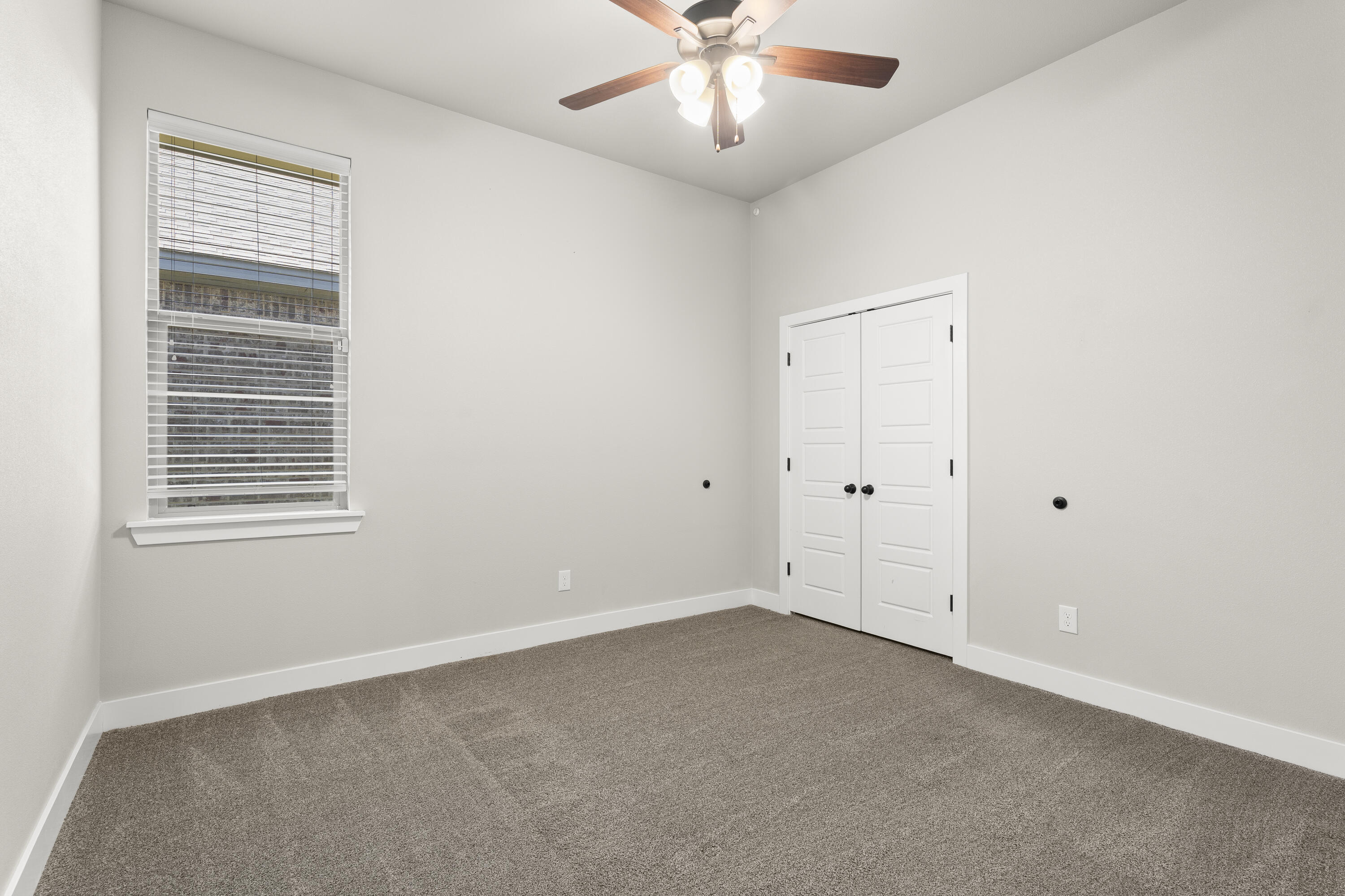 7605 58th Street Lubbock, TX 79407 - Photo 14 of 19 an empty room with a window and a fan