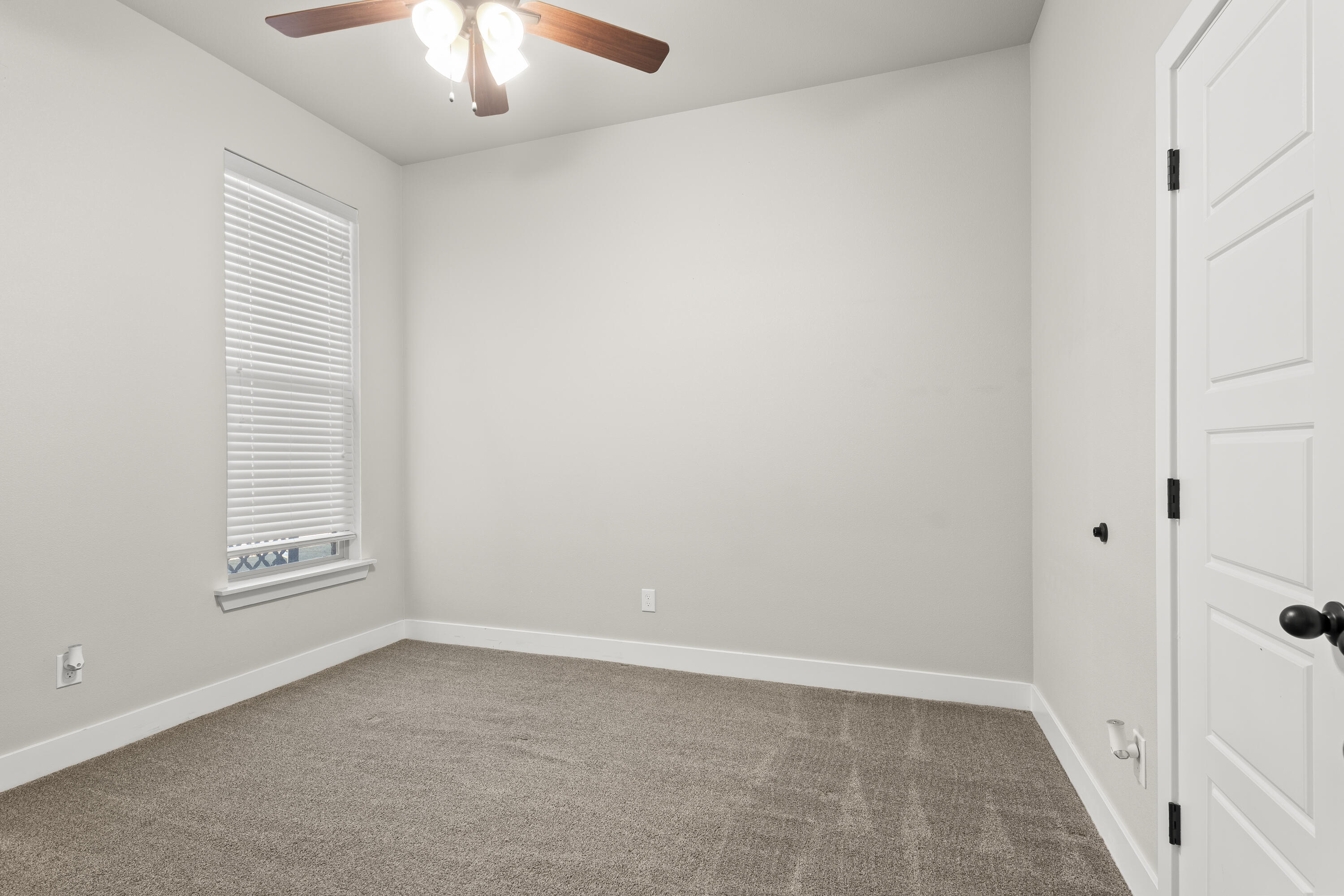 7605 58th Street Lubbock, TX 79407 - Photo 15 of 19 en empty room with windows and chandelier fan