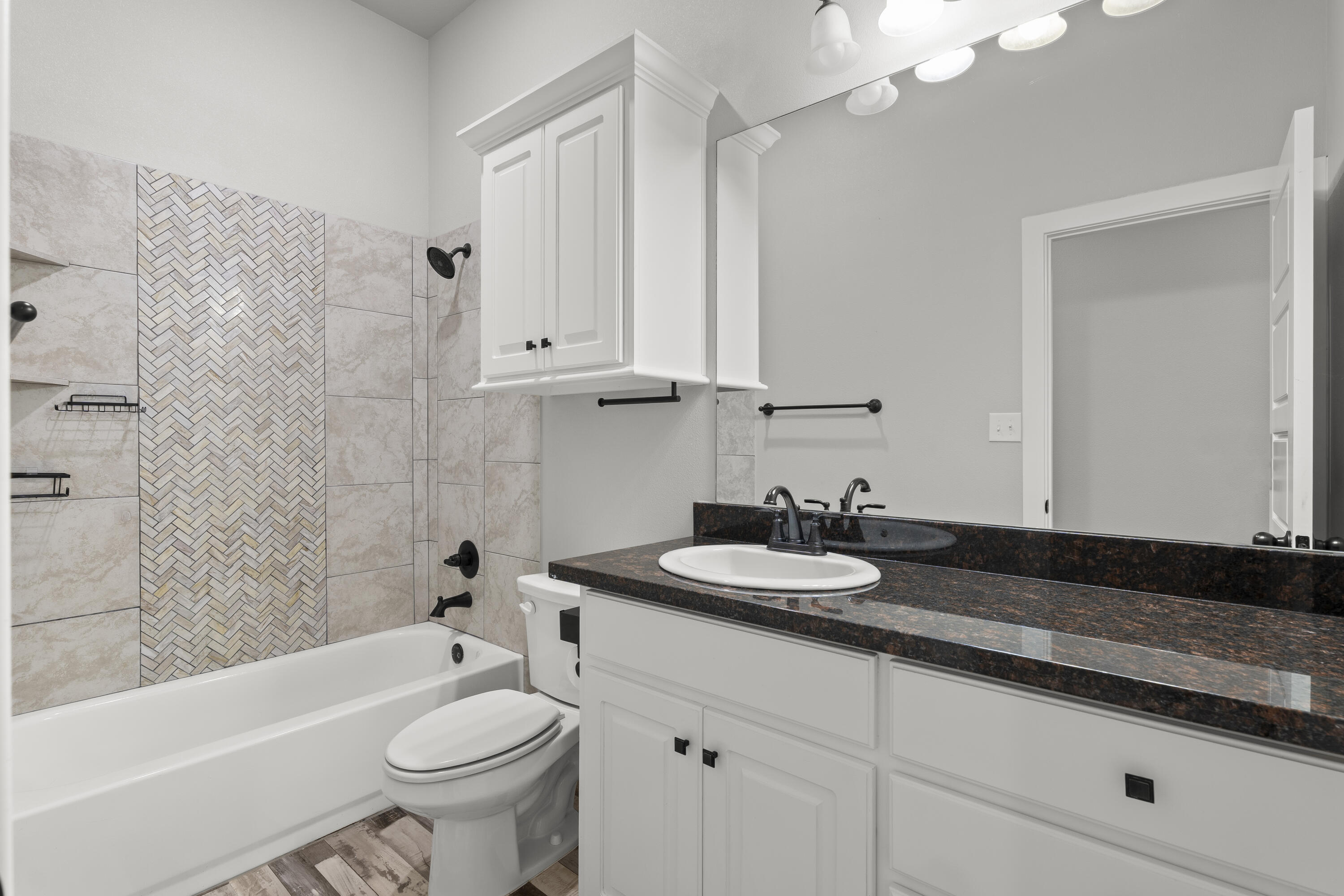 7605 58th Street Lubbock, TX 79407 - Photo 16 of 19 a bathroom with a sink a toilet and bathtub