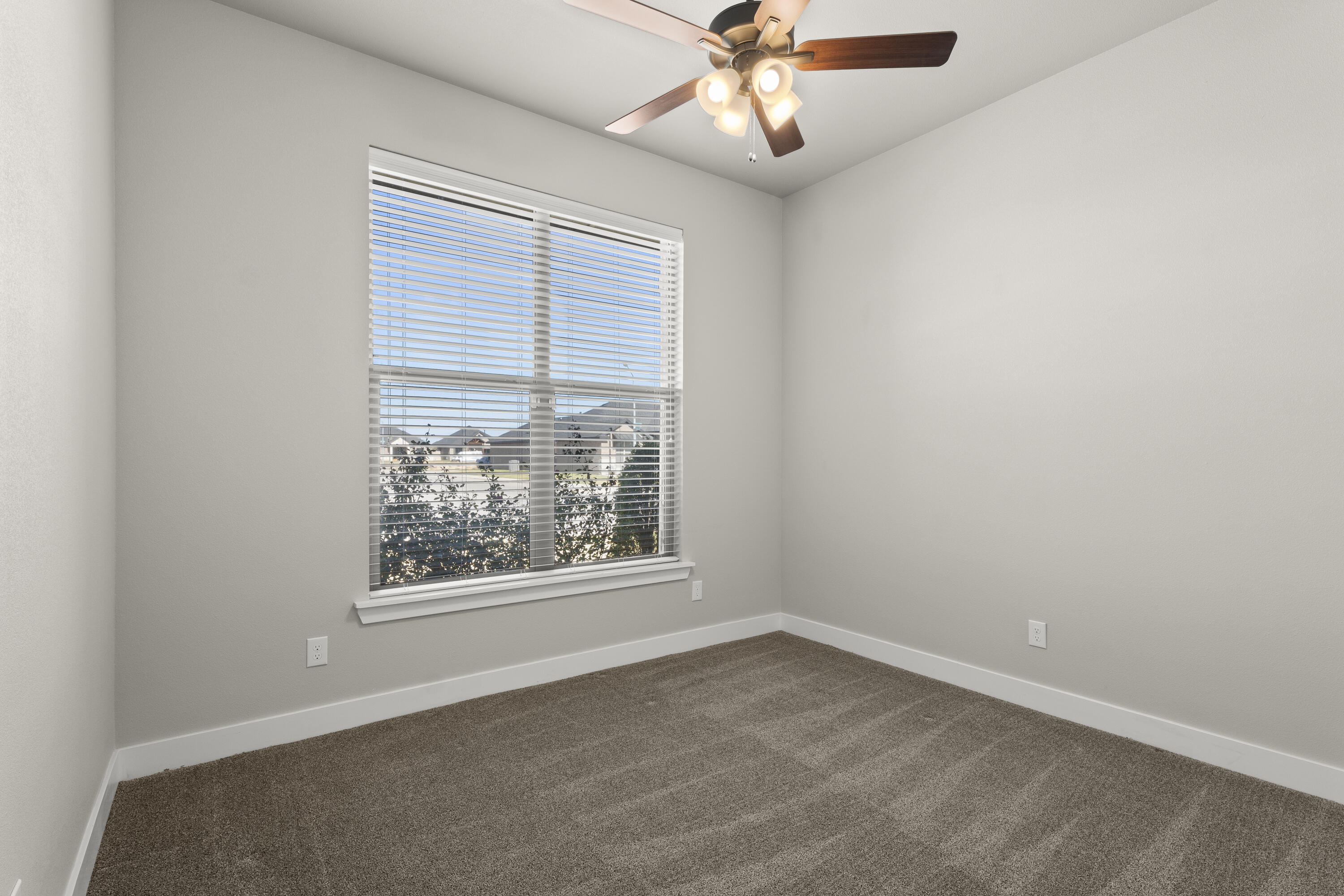 7605 58th Street Lubbock, TX 79407 - Photo 17 of 19 an empty room with a window and a fan