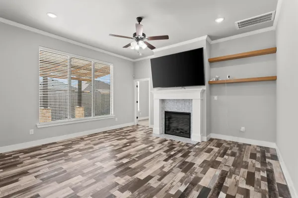 a view of an empty room with a fireplace and a window